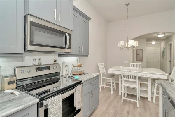 a kitchen with a stove a sink and a microwave