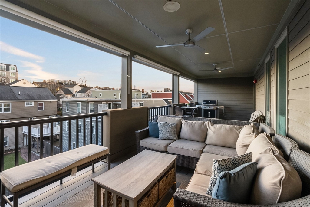 405 West First Street, Unit 303 Boston, MA 02127 - Photo 11 of 29 a living room with furniture and a floor to ceiling window