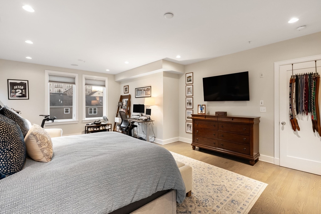 405 West First Street, Unit 303 Boston, MA 02127 - Photo 14 of 29 a bedroom with furniture and a flat screen tv