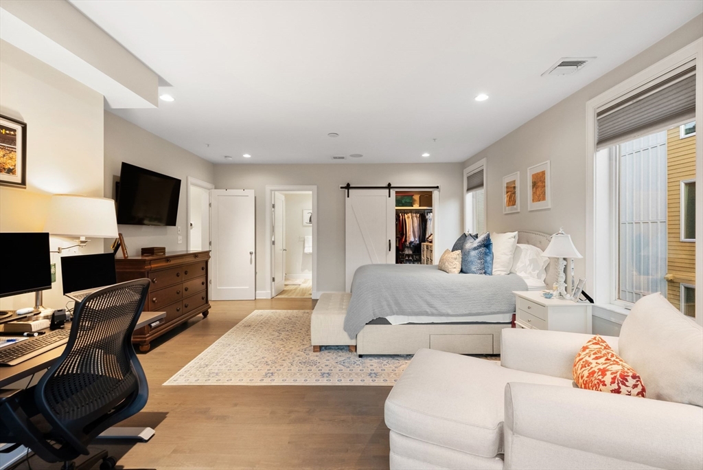 405 West First Street, Unit 303 Boston, MA 02127 - Photo 15 of 29 a living room with furniture and a flat screen tv