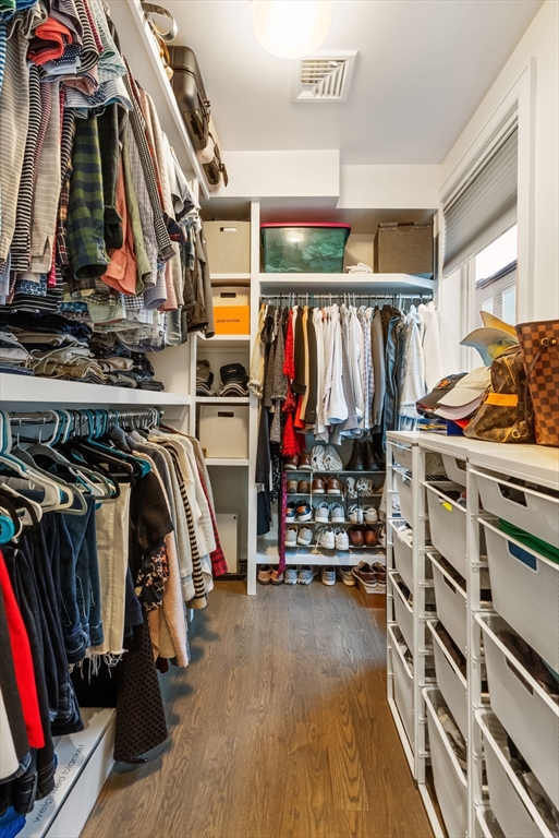 405 West First Street, Unit 303 Boston, MA 02127 - Photo 16 of 29 a view of walk in closet with clothes and shoes