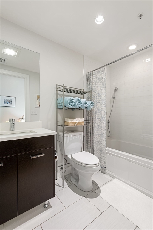 405 West First Street, Unit 303 Boston, MA 02127 - Photo 21 of 29 a bathroom with a sink toilet a mirror and shower