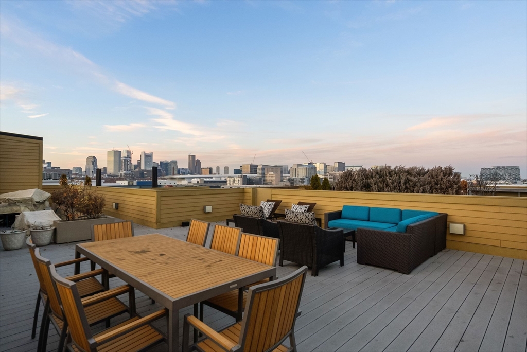 405 West First Street, Unit 303 Boston, MA 02127 - Photo 22 of 29 a terrace with outdoor seating and city view