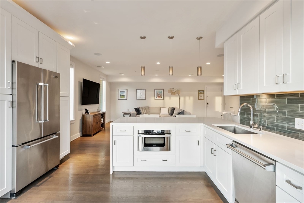 405 West First Street, Unit 303 Boston, MA 02127 - Photo 4 of 29 a kitchen with white cabinets and stainless steel appliances