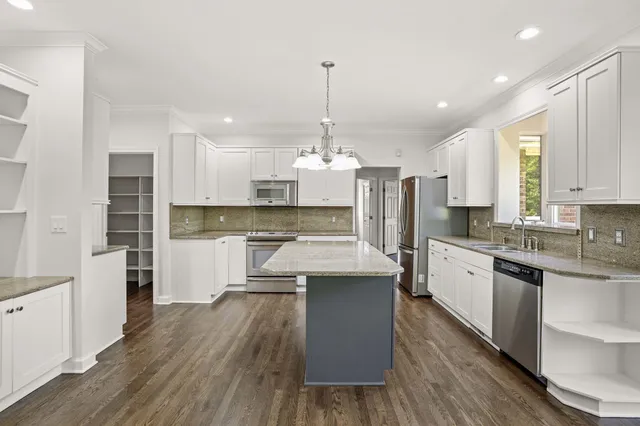 a view of an empty room with a fireplace and a window