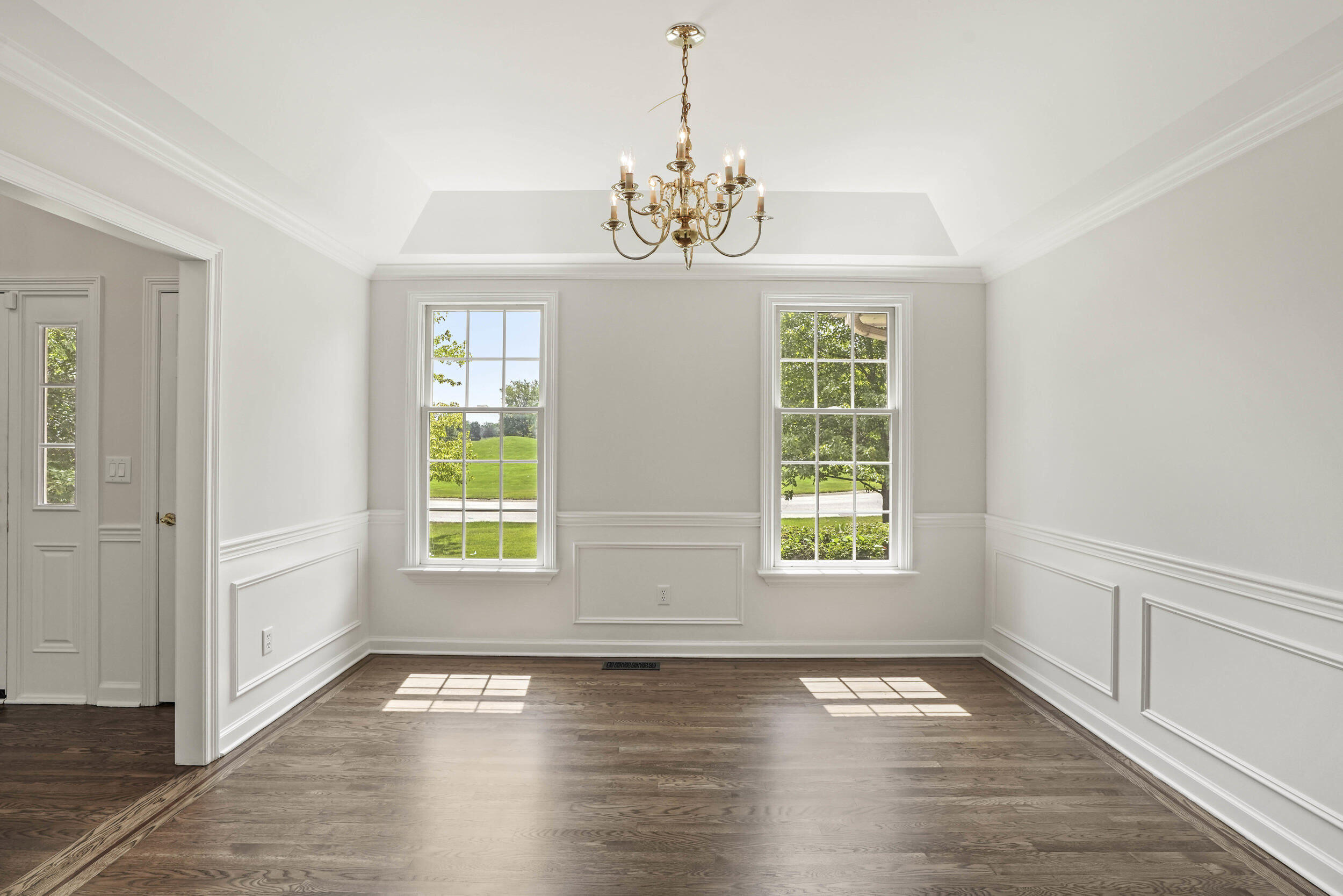 1500 Nelson Drive Chesterton, IN 46304 - Photo 12 of 70 an empty room with wooden floor chandelier and windows