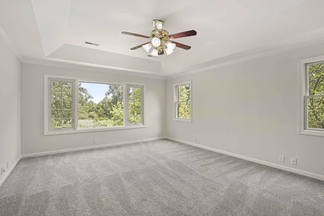 a view of an empty room with a fireplace and a window