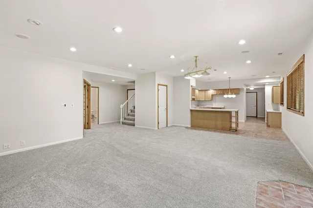 an aerial view of residential houses with outdoor space and trees