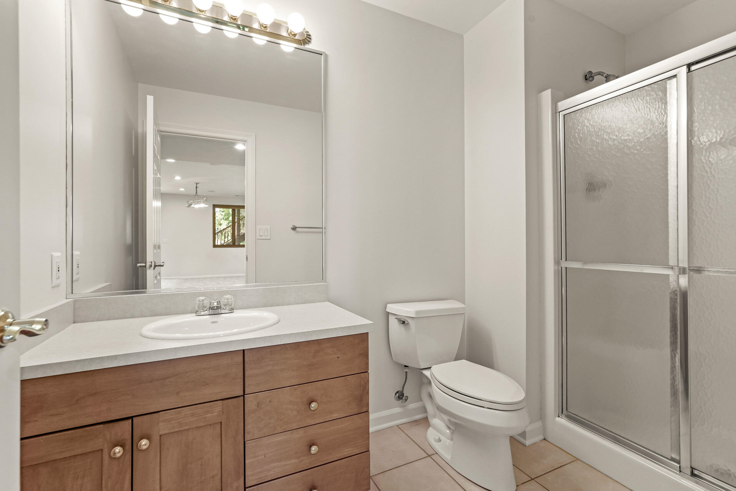 1500 Nelson Drive Chesterton, IN 46304 - Photo 53 of 70 a bathroom with a toilet a sink a mirror and vanity