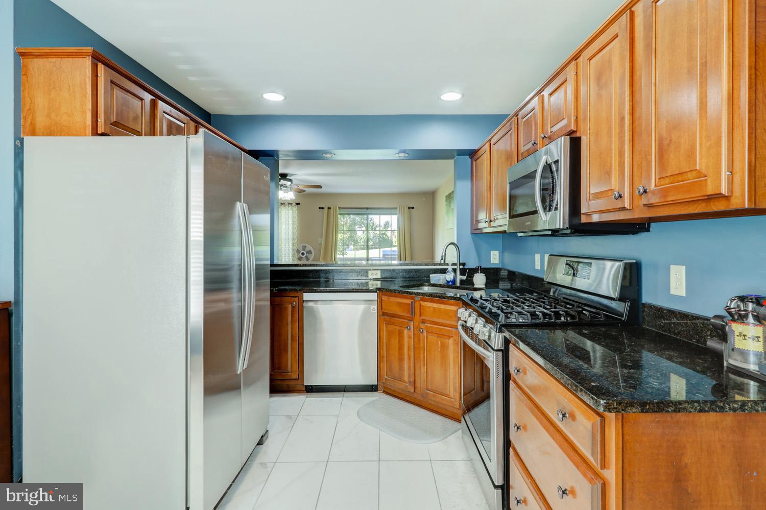 1006 Cobblestone Lane Lancaster, PA 17601 - Photo 13 of 38 a kitchen with stainless steel appliances granite countertop a refrigerator and a sink