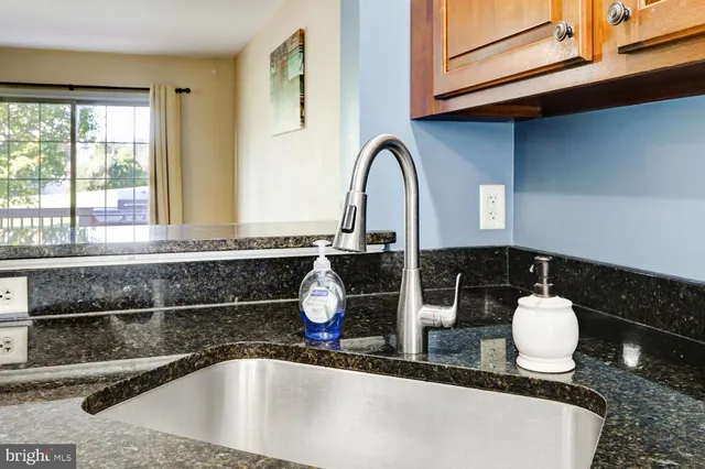 a bathroom with a granite countertop sink a mirror and vanity