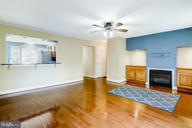a view of an empty room with a fireplace and a window