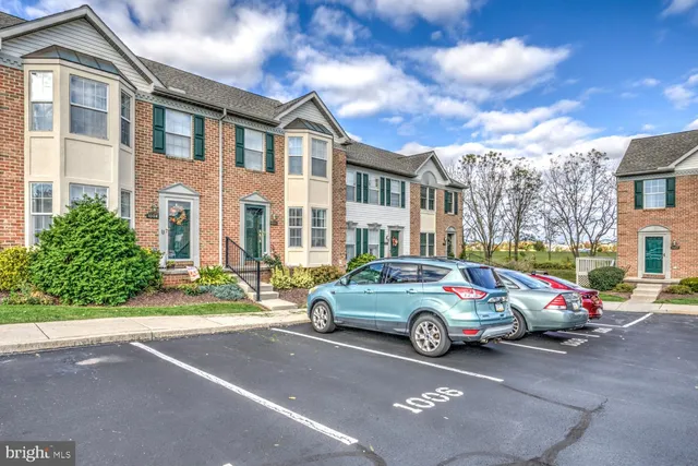 a car parked in front of a brick house