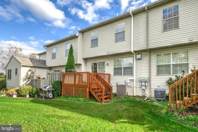 a view of backyard with a garden and deck