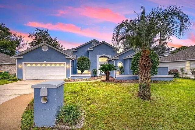 a view of a house with swimming pool and a fire pit
