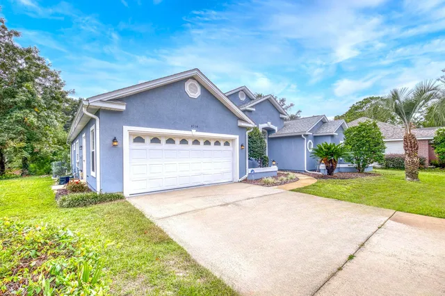 a view of a house with a yard and garage