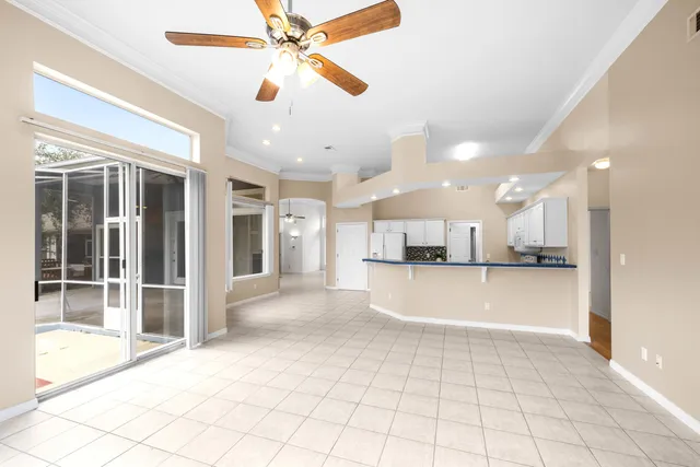 a kitchen with white cabinets and refrigerator