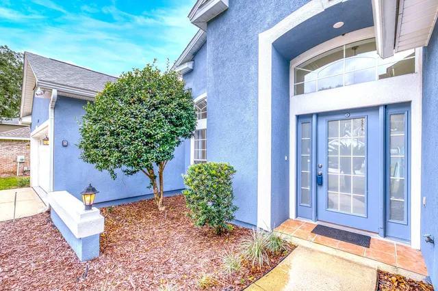 a view of a house with backyard and sitting area