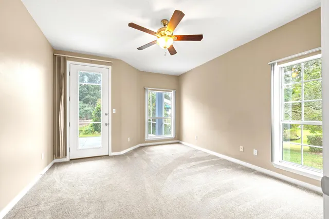 a view of a bedroom with a window and a hardwood floor