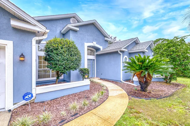 a front view of a house with garden