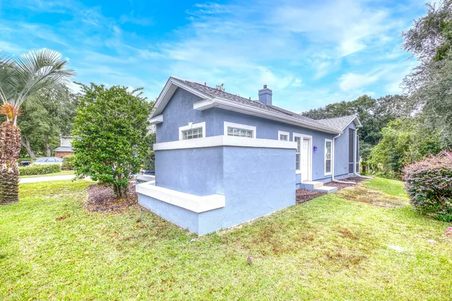 a view of a house with backyard and sitting area