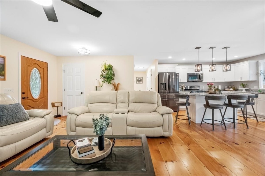 1085 Southbridge Road Warren, MA 01585 - Photo 6 of 31 a living room with furniture kitchen view and a wooden floor
