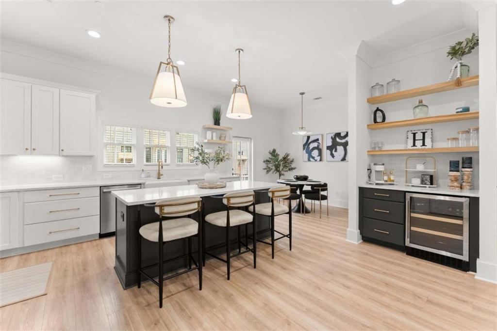 338 Sugarview Road Sugar Hill, GA 30518 - Photo 11 of 74 a kitchen with stainless steel appliances a dining table chairs stove and cabinets