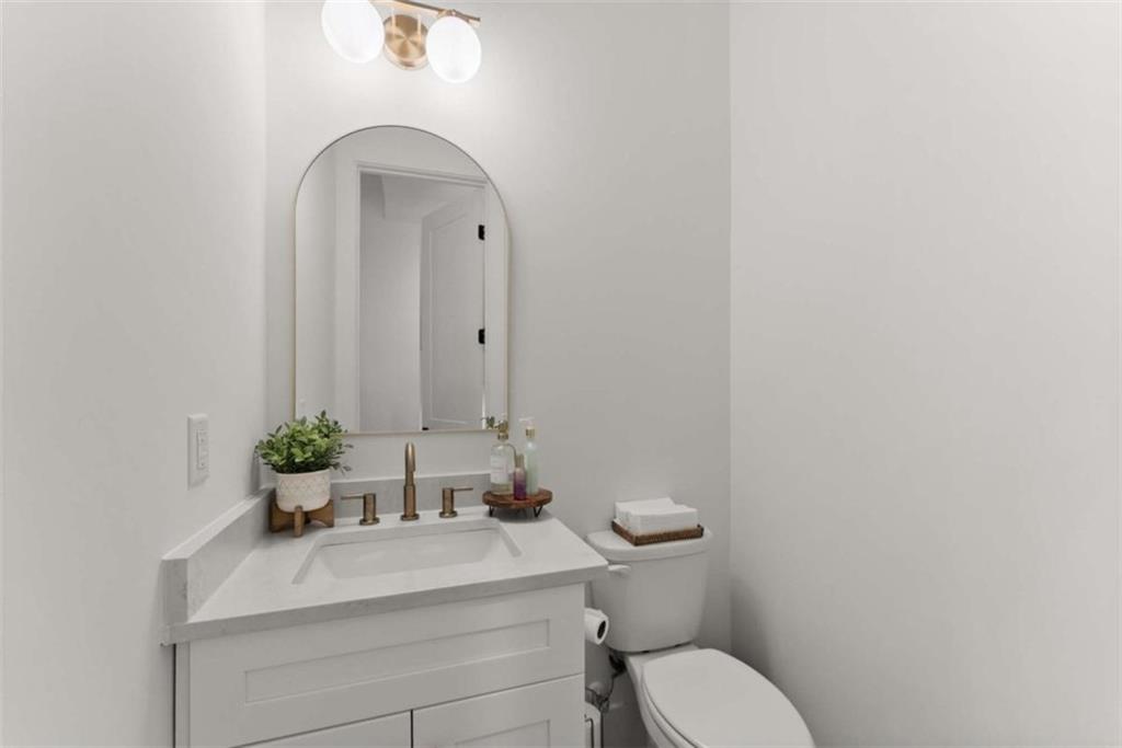 338 Sugarview Road Sugar Hill, GA 30518 - Photo 22 of 74 a bathroom with a sink mirror and toilet