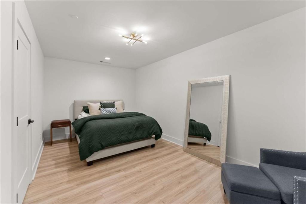 338 Sugarview Road Sugar Hill, GA 30518 - Photo 24 of 74 a bedroom with a bed and a couch