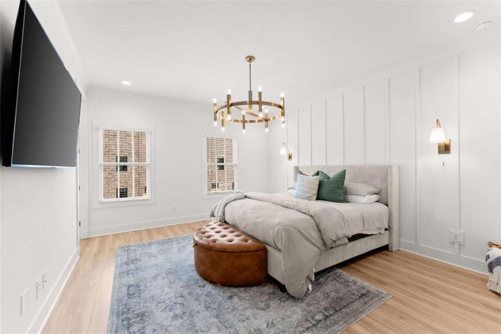 338 Sugarview Road Sugar Hill, GA 30518 - Photo 29 of 74 a spacious bedroom with a bed and a chandelier