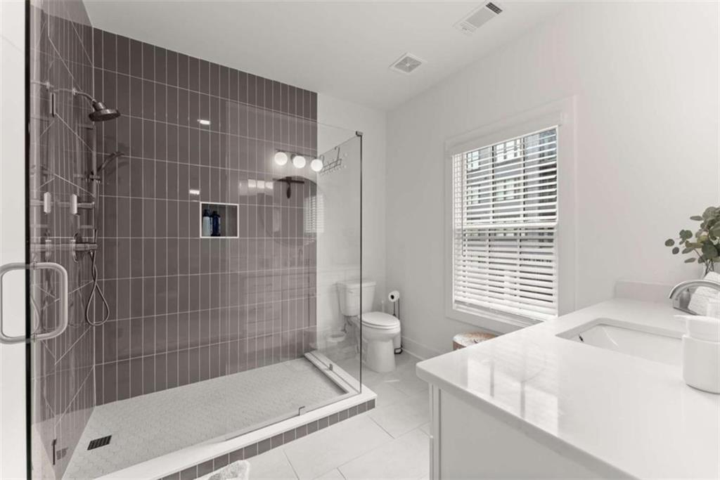 338 Sugarview Road Sugar Hill, GA 30518 - Photo 40 of 74 a bathroom with a bathtub and shower