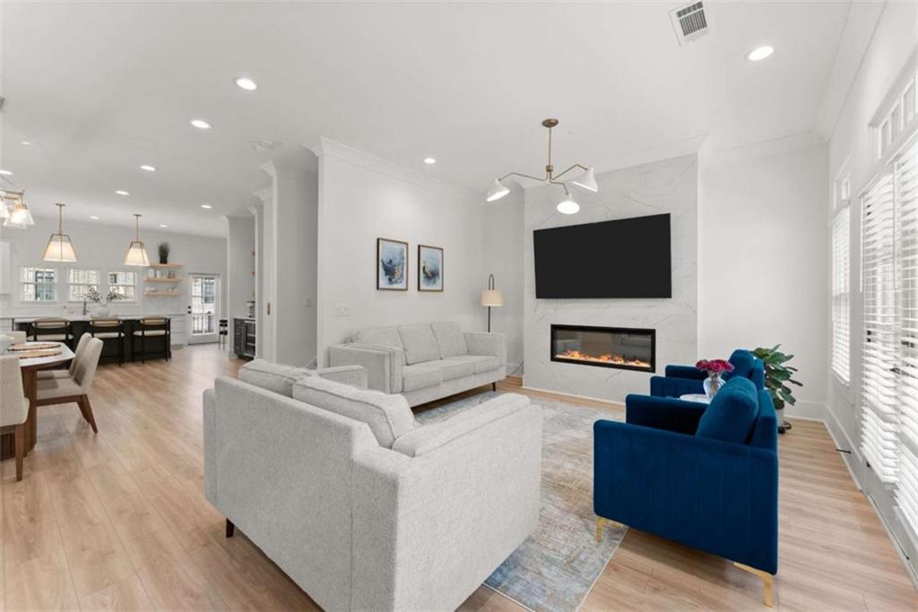 338 Sugarview Road Sugar Hill, GA 30518 - Photo 4 of 74 a living room with furniture a fireplace and a flat screen tv