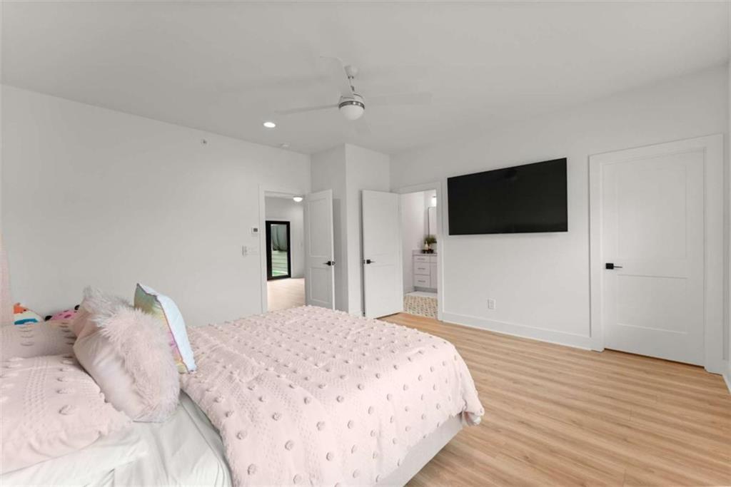 338 Sugarview Road Sugar Hill, GA 30518 - Photo 47 of 74 a bedroom with a bed and a flat screen tv