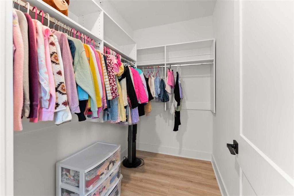 338 Sugarview Road Sugar Hill, GA 30518 - Photo 48 of 74 a view of walk in closet with clothes and shoes