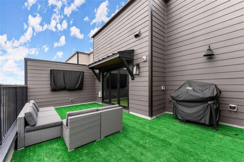 338 Sugarview Road Sugar Hill, GA 30518 - Photo 50 of 74 a backyard of a house with barbeque oven and couches