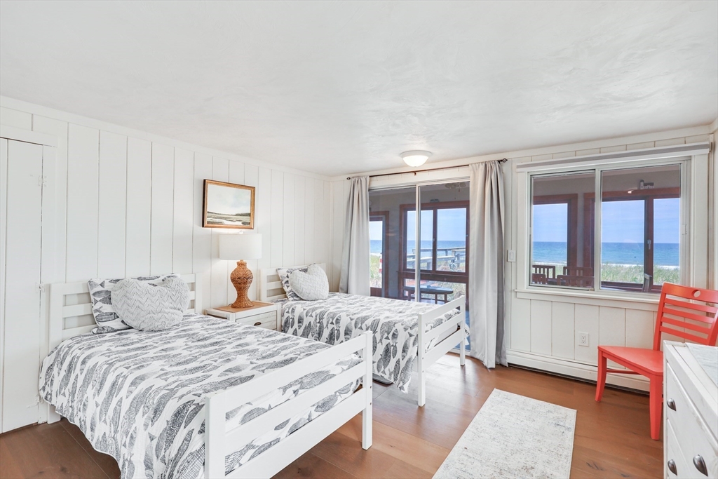 213 Phillips Road Sandwich, MA 02563 - Photo 20 of 36 a bedroom with a large bed and a balcony