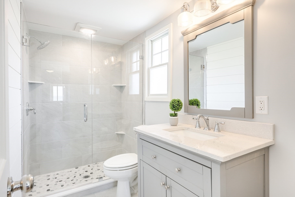 213 Phillips Road Sandwich, MA 02563 - Photo 27 of 36 a bathroom with a sink a toilet a shower and a mirror