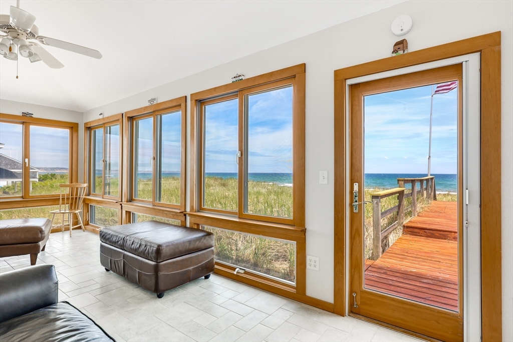 213 Phillips Road Sandwich, MA 02563 - Photo 8 of 36 a living room with furniture and a floor to ceiling window