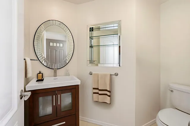 a bathroom with a sink a mirror and a toilet