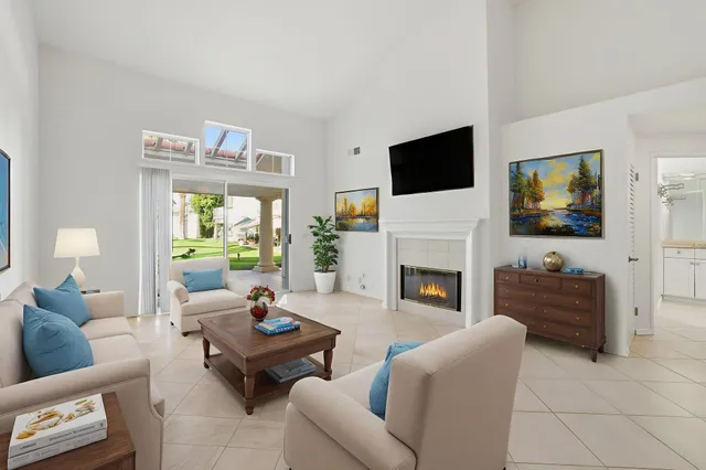 a living room with furniture fireplace and a flat screen tv