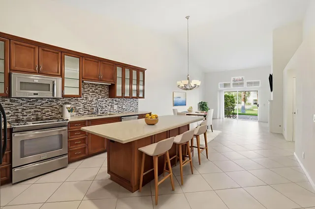 a kitchen with a stove a sink a table and chairs