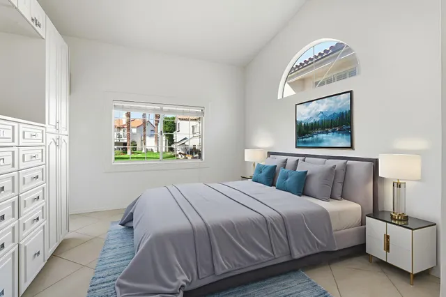 a bedroom with a bed and a painting on the wall