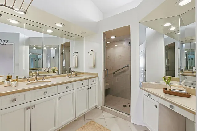 a bathroom with a shower sink and mirror