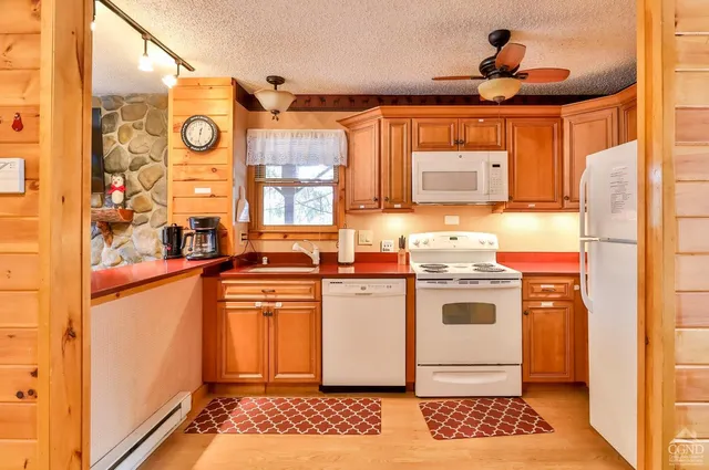 a kitchen with a stove a sink and a refrigerator