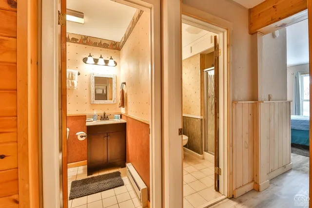a bathroom with a glass door shower and a sink
