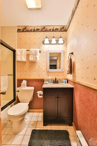 a bathroom with a toilet a sink and mirror