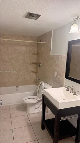 a bathroom with a sink vanity and a mirror