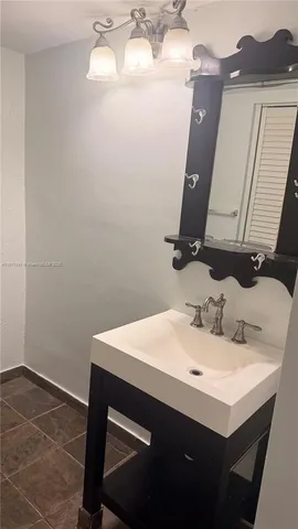 a bathroom with a toilet a sink and a mirror