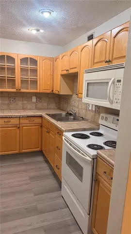 a kitchen with stainless steel appliances granite countertop a stove and a sink