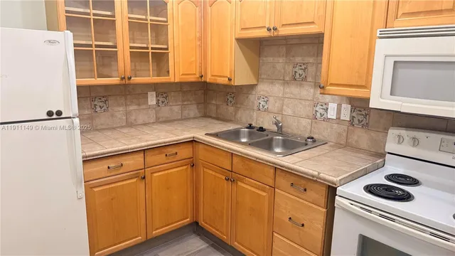 a kitchen with a sink cabinets and appliances